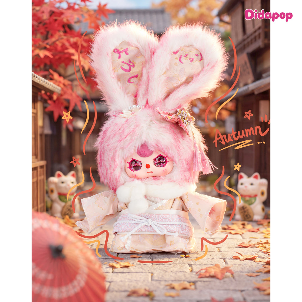 Baby Three Japan 400% pink bunny plush in a kimono with white scarf and pink tassel in an autumn scene