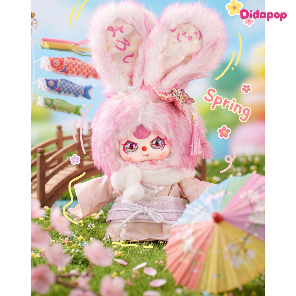 Pink Baby Three Japan 400% plush with a floral kimono and tassel hair accessory in a spring scene
